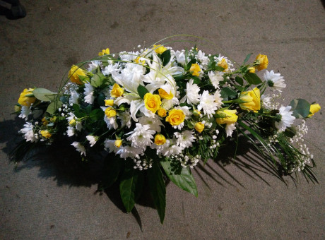 Funeral spray of yellow roses