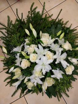 Funeral wreath with white roses and lilies