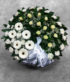 Funeral wreath of freshly cut yellow roses, white gerberas and chrysanthemums