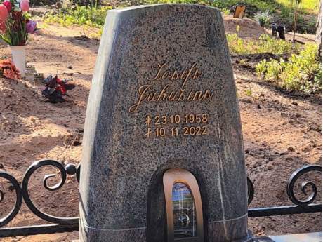 Granite tombstone in a conical shape with an integrated candle holder